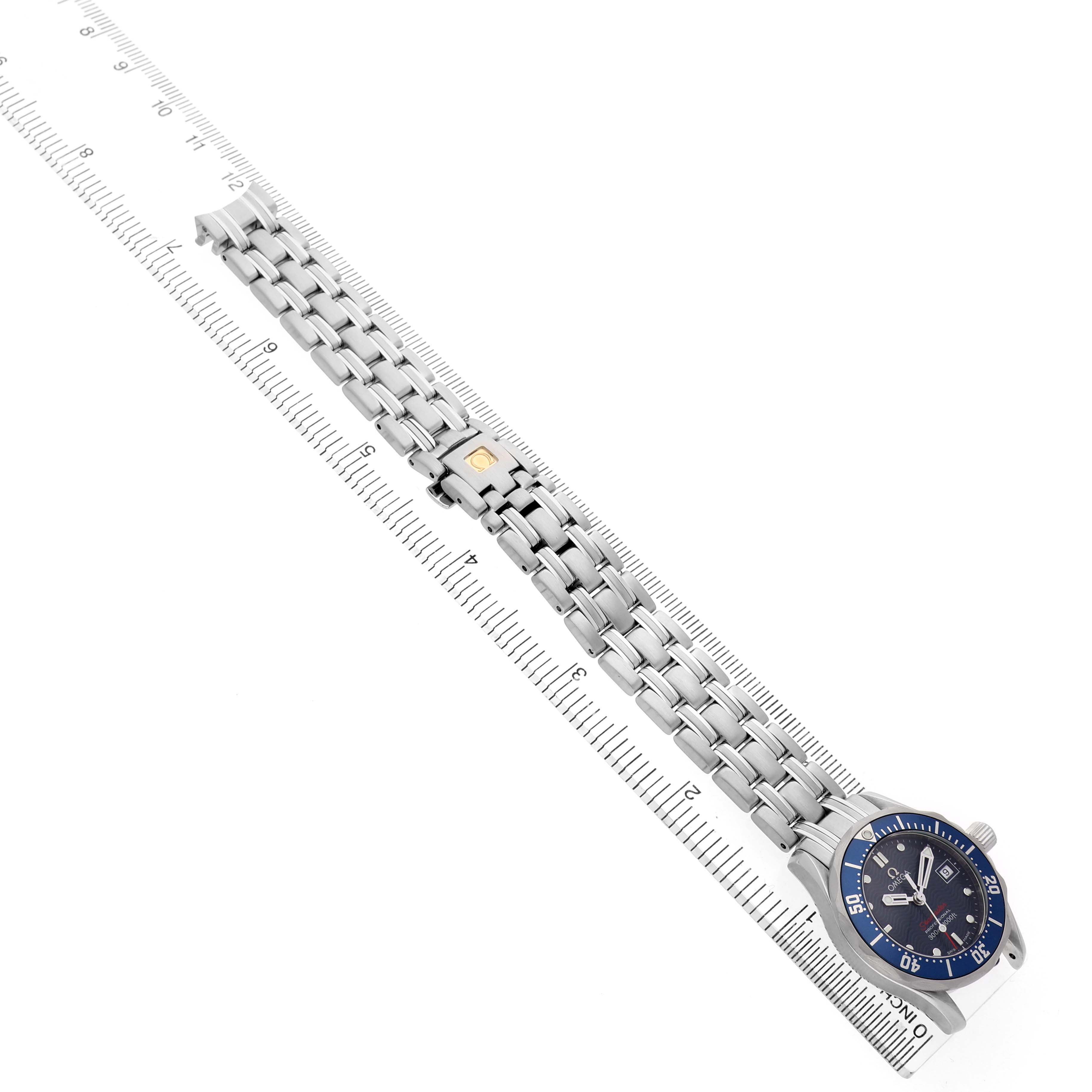 The Omega 2224.80.00 Women's Stainless Steel Blue Dial Seamaster Diver 300M Steel Blue Dial Ladies Watch is shown at an angle highlighting the full bracelet and face next to a ruler.