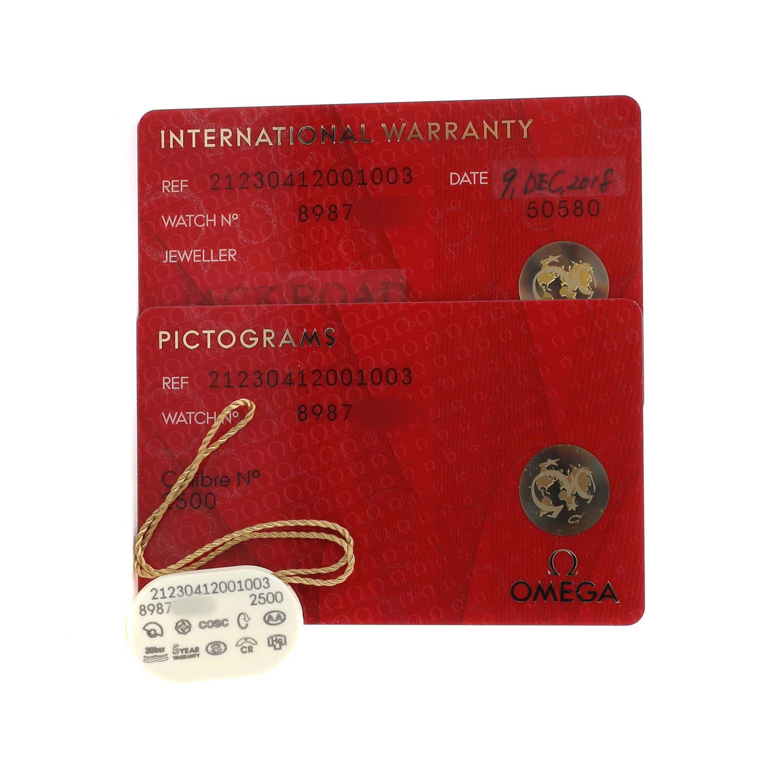 The image shows two red Omega Seamaster 212.30.41.20.01.003 Men's Stainless Steel Black Dial documents: an international warranty and a pictograms card, along with a tan tag.