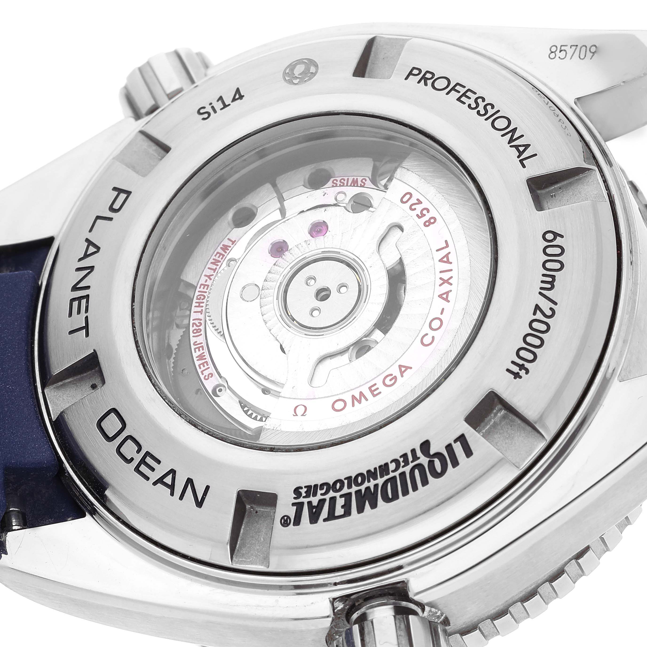 The image shows the back case of the Omega Planet Ocean 232.92.38.20.03.001 Men
s Titanium Blue Dial 232.92.38.20.03.001 Men
s Titanium Blue Dial watch, highlighting its movement mechanism and engravings.