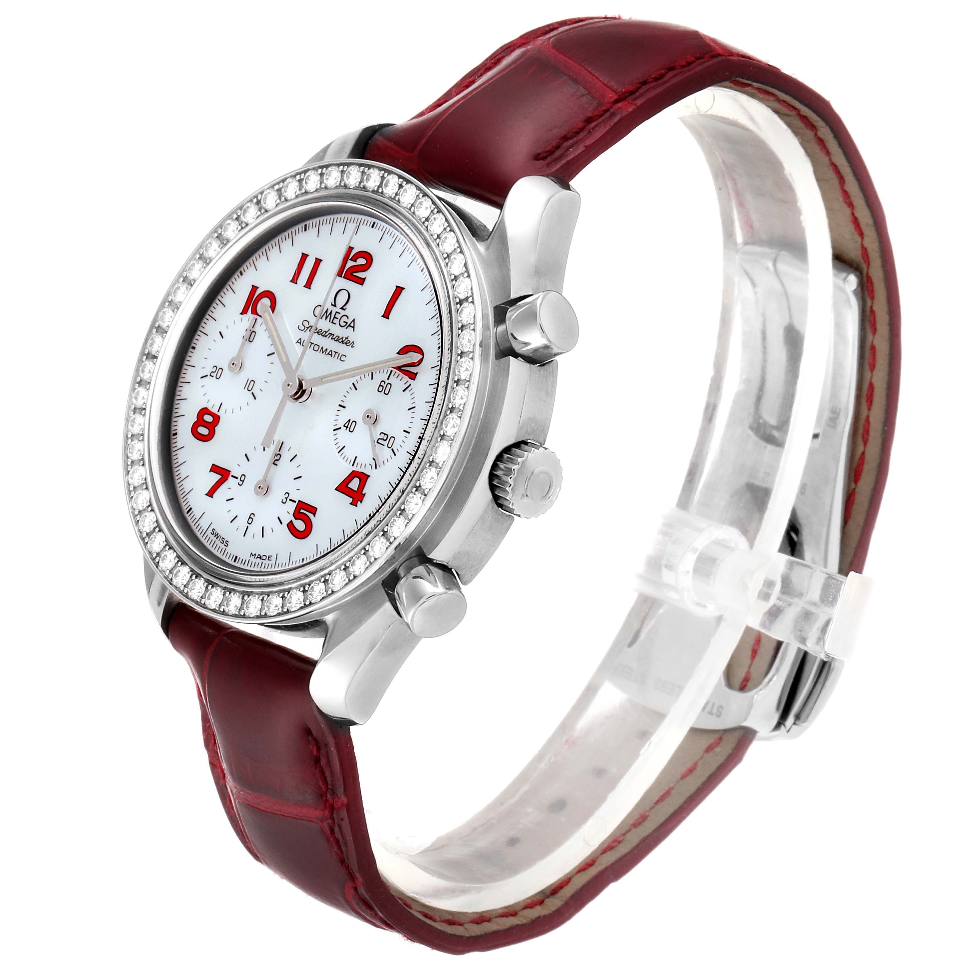 The image shows an Omega 3815.79.40 Women's Stainless Steel Mother of Pearl Dial 3815.79.40 Women's Stainless Steel Mother of Pearl Dial Speedmaster MOP Diamond Red Strap Ladies Watch 3815.79.40 from an angled view, emphasizing the face, strap, and bezel.