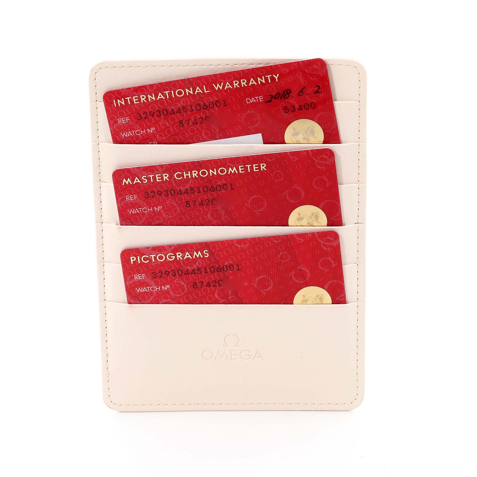 The image shows the warranty cards for an Omega Speedmaster 329.30.44.51.06.001 Men's Stainless Steel Grey Dial 329.30.44.51.06.001 Men's Stainless Steel Grey Dial watch, placed in a white cardholder.