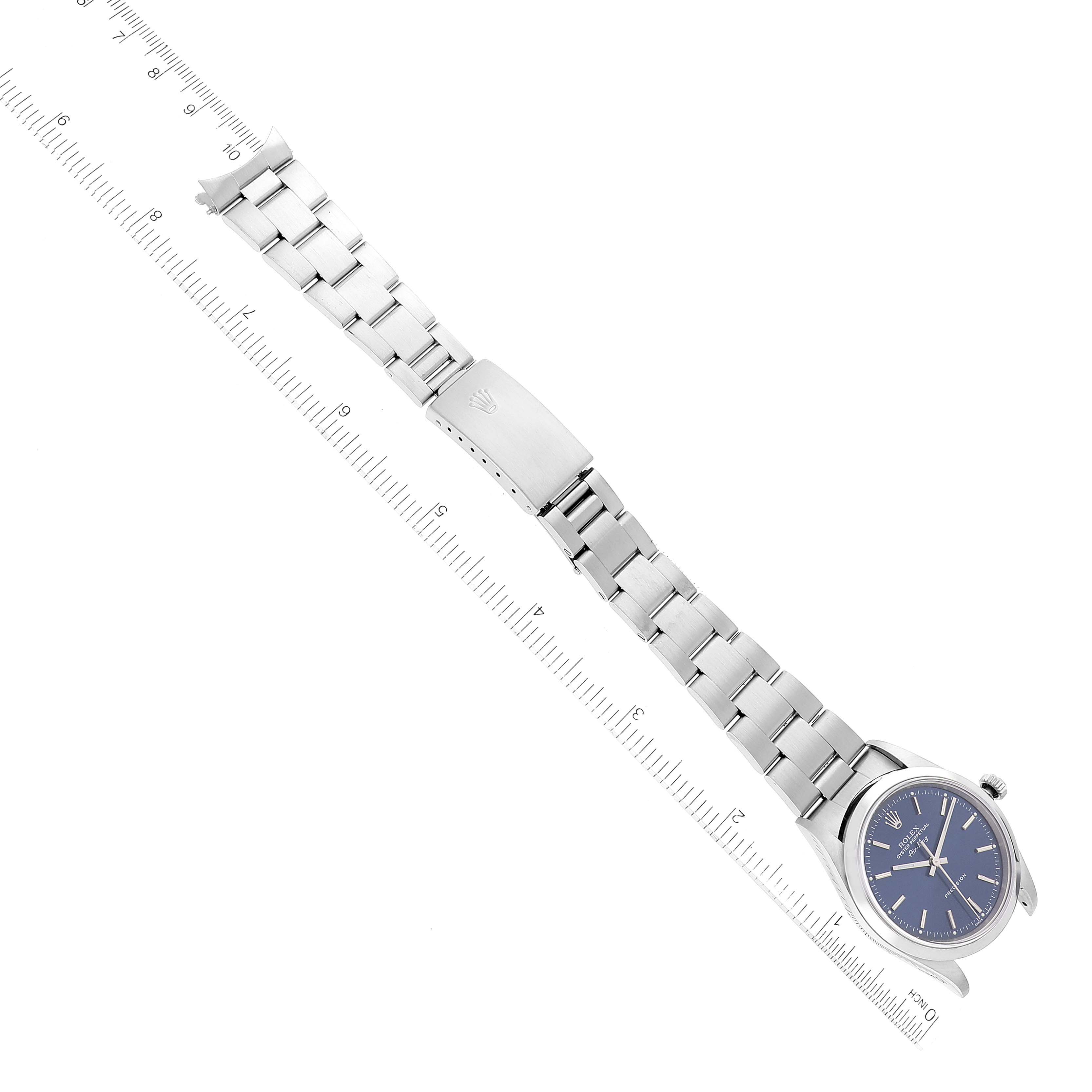 This image shows a top-down view of a Rolex Air-King 14000 Men's Stainless Steel Blue Dial 14000 Men's Stainless Steel Blue Dial watch, displaying its face and metal bracelet against a ruler.