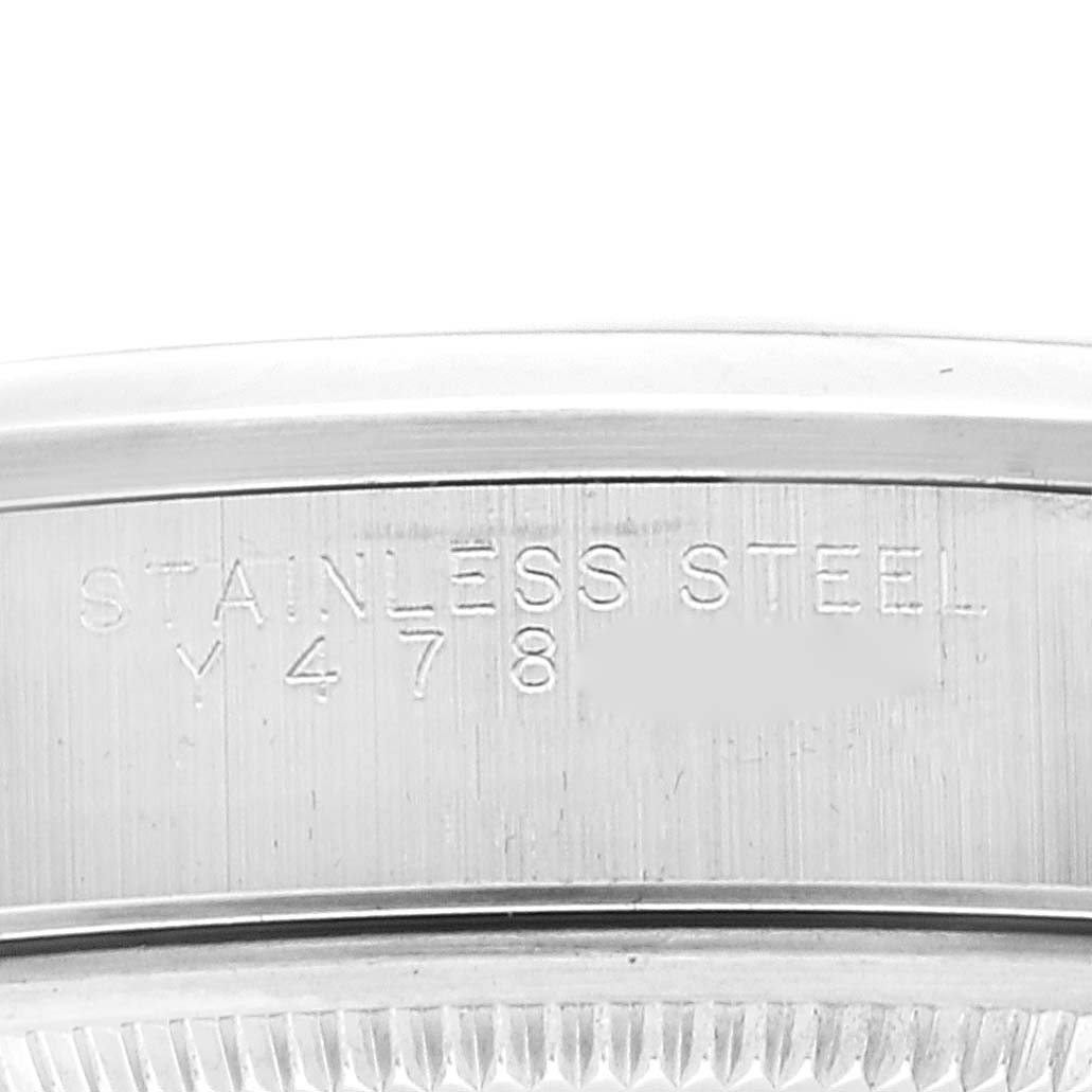 This image shows a close-up of the stainless steel case back of an Air-King model by Rolex.