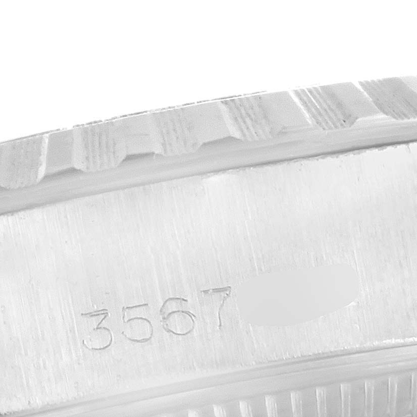 The image shows a close-up of the Rolex Date 6924 Women
s Stainless Steel Silver Dial 6924 Women
s Stainless Steel Silver Dial model watch
s case and serial number engraving.