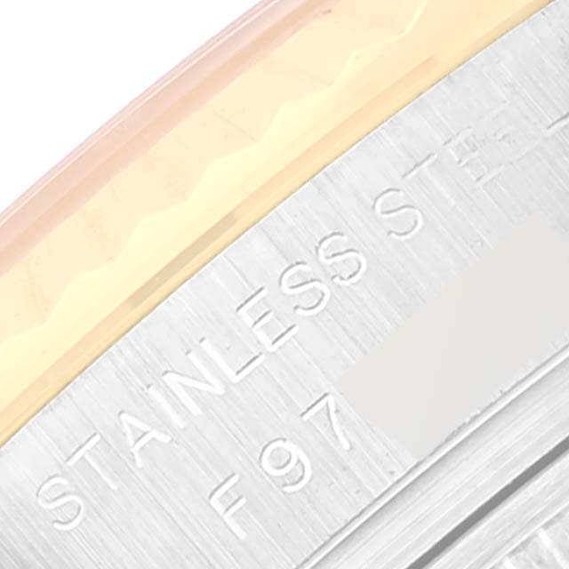 This close-up image shows the engraved edge of a stainless steel component on a Rolex Datejust 179173 Women's Steel and Gold (two tone) Grey Dial 179173 Women's Steel and Gold (two tone) Grey Dial watch.