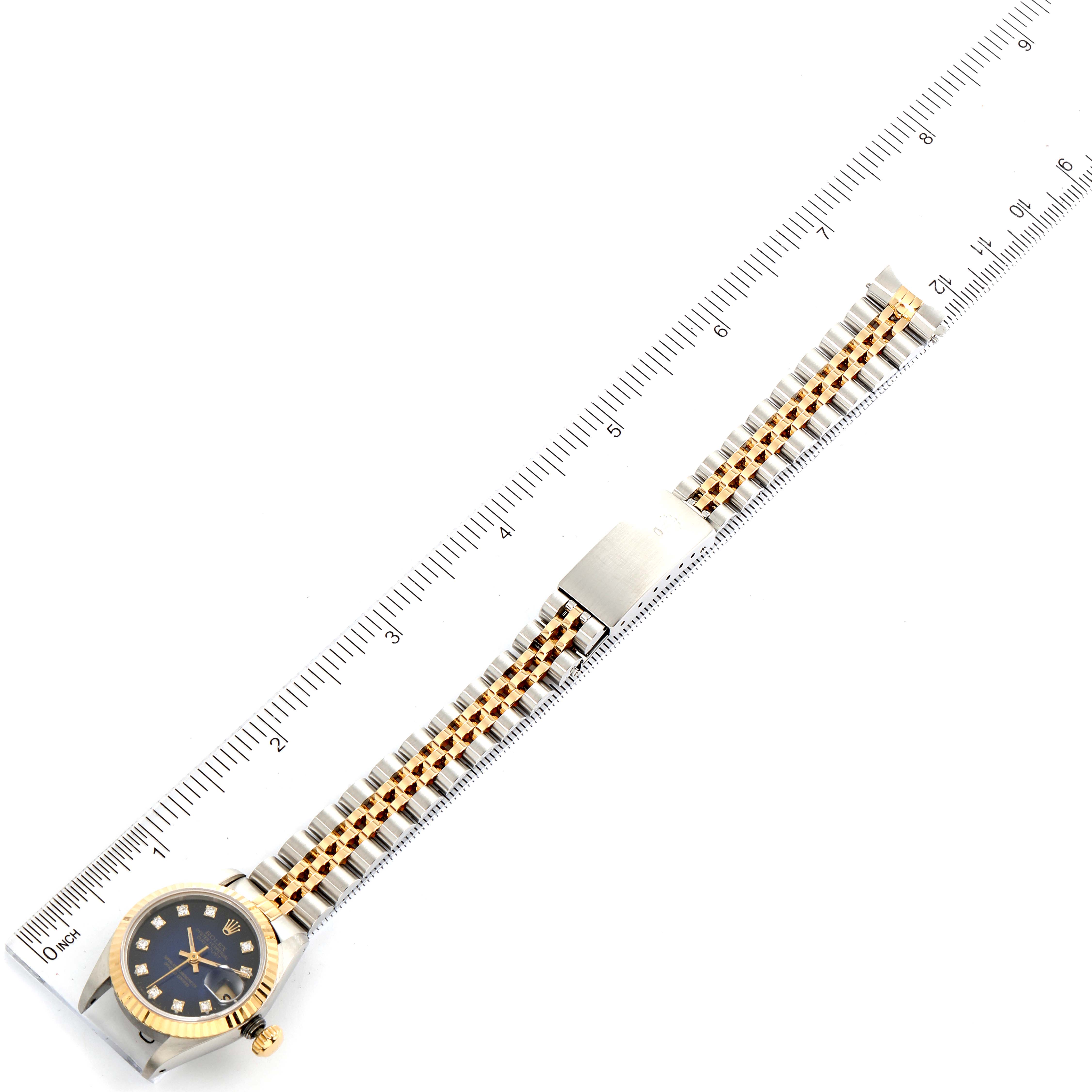 The image shows a Rolex Datejust 69173 Women's Steel and Gold (two tone) Blue Dial 69173 Women's Steel and Gold (two tone) Blue Dial watch lying flat alongside a ruler, displaying the face, crown, and bracelet.