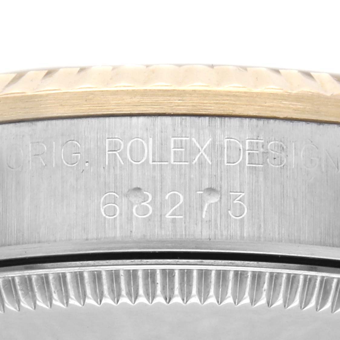The image shows a close-up of the side of a Rolex Mid-Size 68273 Women's Steel and Gold (two tone) Champagne Dial 68273 Women's Steel and Gold (two tone) Champagne Dial model watch, highlighting the engraved model number and bezel.