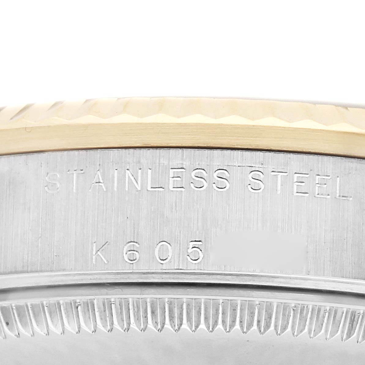 The image shows a close-up of the case side of a Rolex Mid-Size 178273 Women
s Steel and Gold (two tone) Silver Dial 178273 Women
s Steel and Gold (two tone) Silver Dial watch, displaying "STAINLESS STEEL" and part of the serial number.