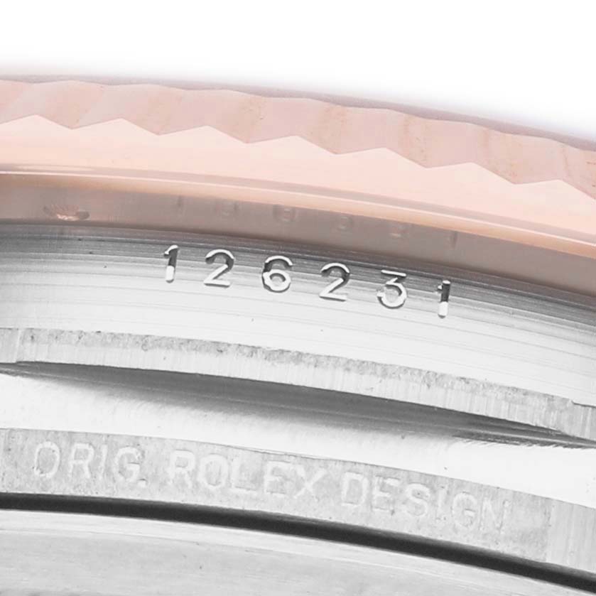 The image shows a close-up of the Rolex Datejust 126231 Men's Rose Gold White Dial model's case side, displaying the model number engraved on it.