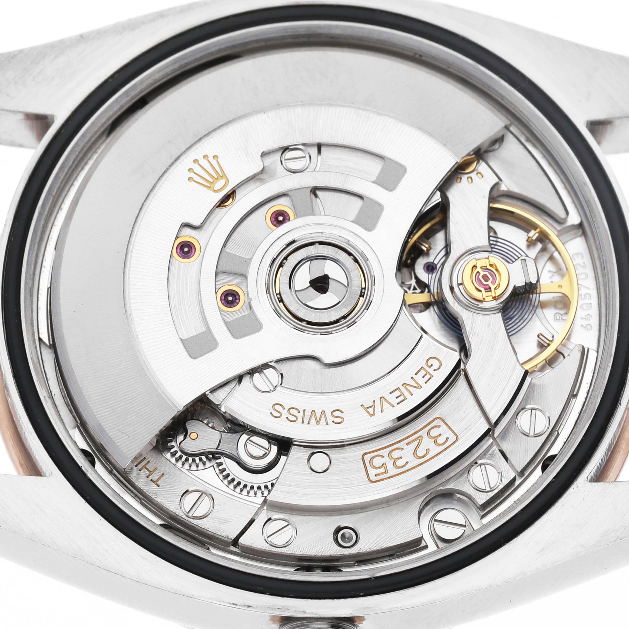 The image shows the movement of a Rolex Datejust 126231 Men's Rose Gold White Dial watch from the back, highlighting its intricate inner mechanism.
