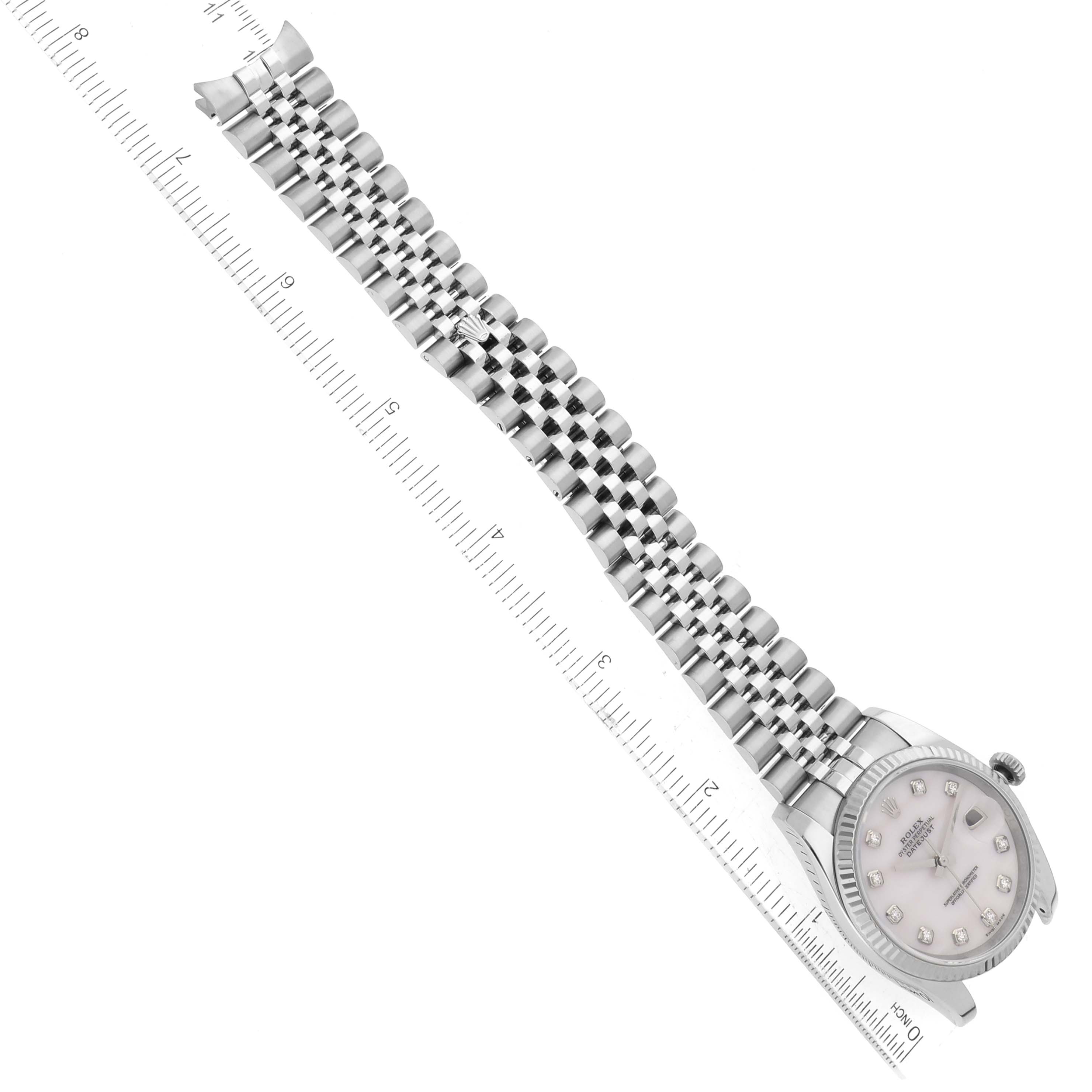 The image shows a top view of a Rolex Datejust 116234 Men's Stainless Steel Mother of Pearl Dial 116234 Men's Stainless Steel Mother of Pearl Dial watch with a silver jubilee bracelet, aligned with a ruler for scale.