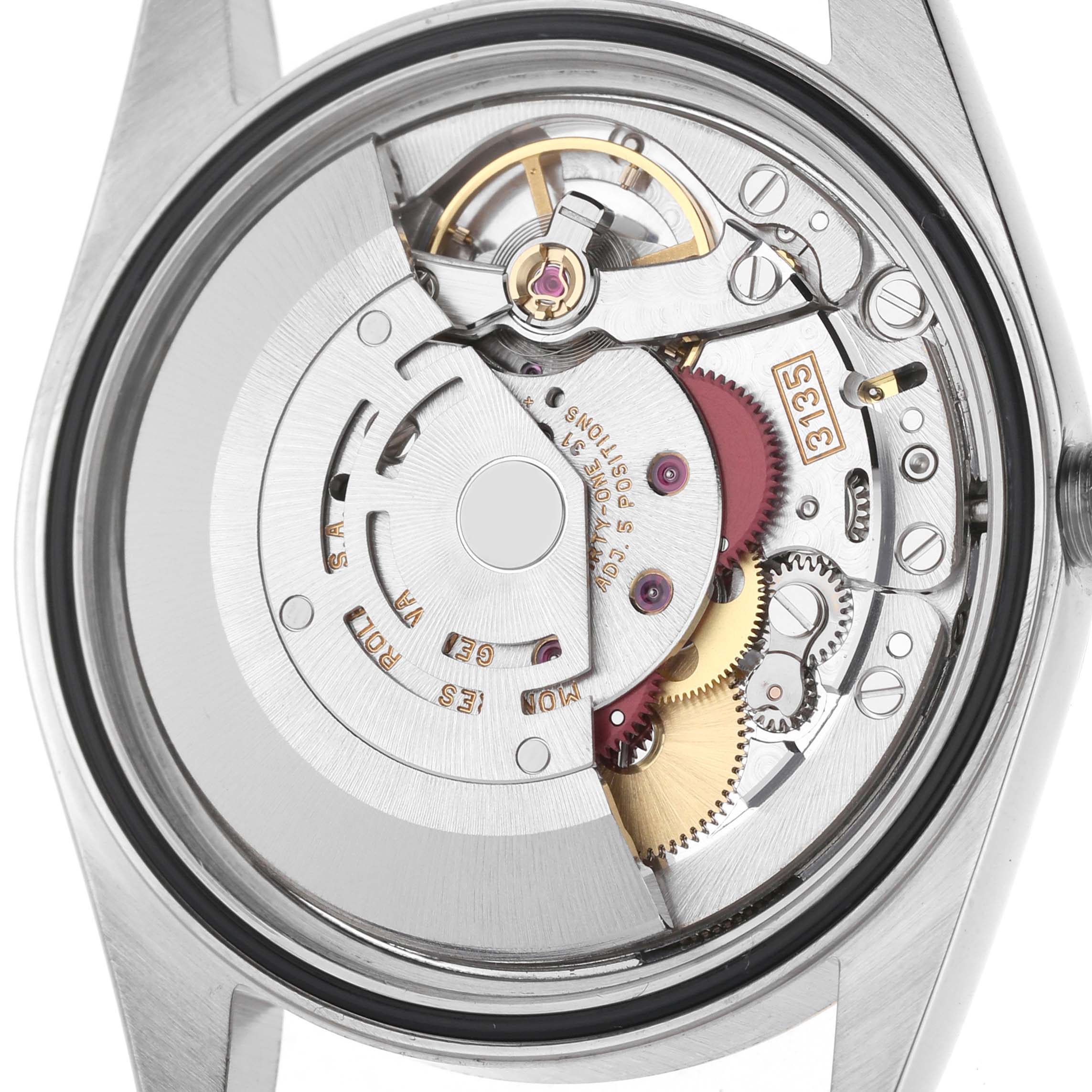 The image shows the intricate movement of a Rolex Datejust 16233 Men's Stainless Steel White Dial watch from a back angle, revealing its gears and rotor.