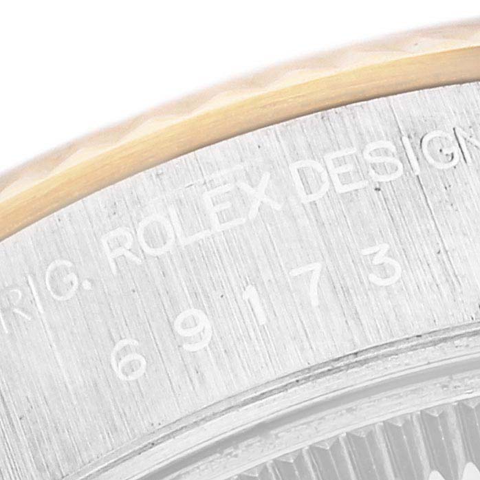 The image shows a close-up of the engraved text on the side of the bezel of a Rolex Datejust 69173 Women's Steel and Gold (two tone) Blue Dial 69173 Women's Steel and Gold (two tone) Blue Dial watch.