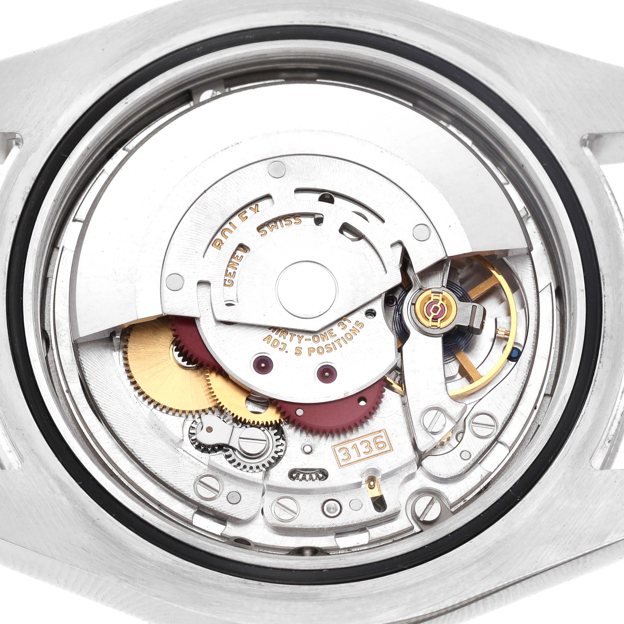 The image shows the movement mechanism of a Rolex Datejust 41 116334 Men's Stainless Steel Blue Dial, viewed from the back, highlighting gears and the rotor.