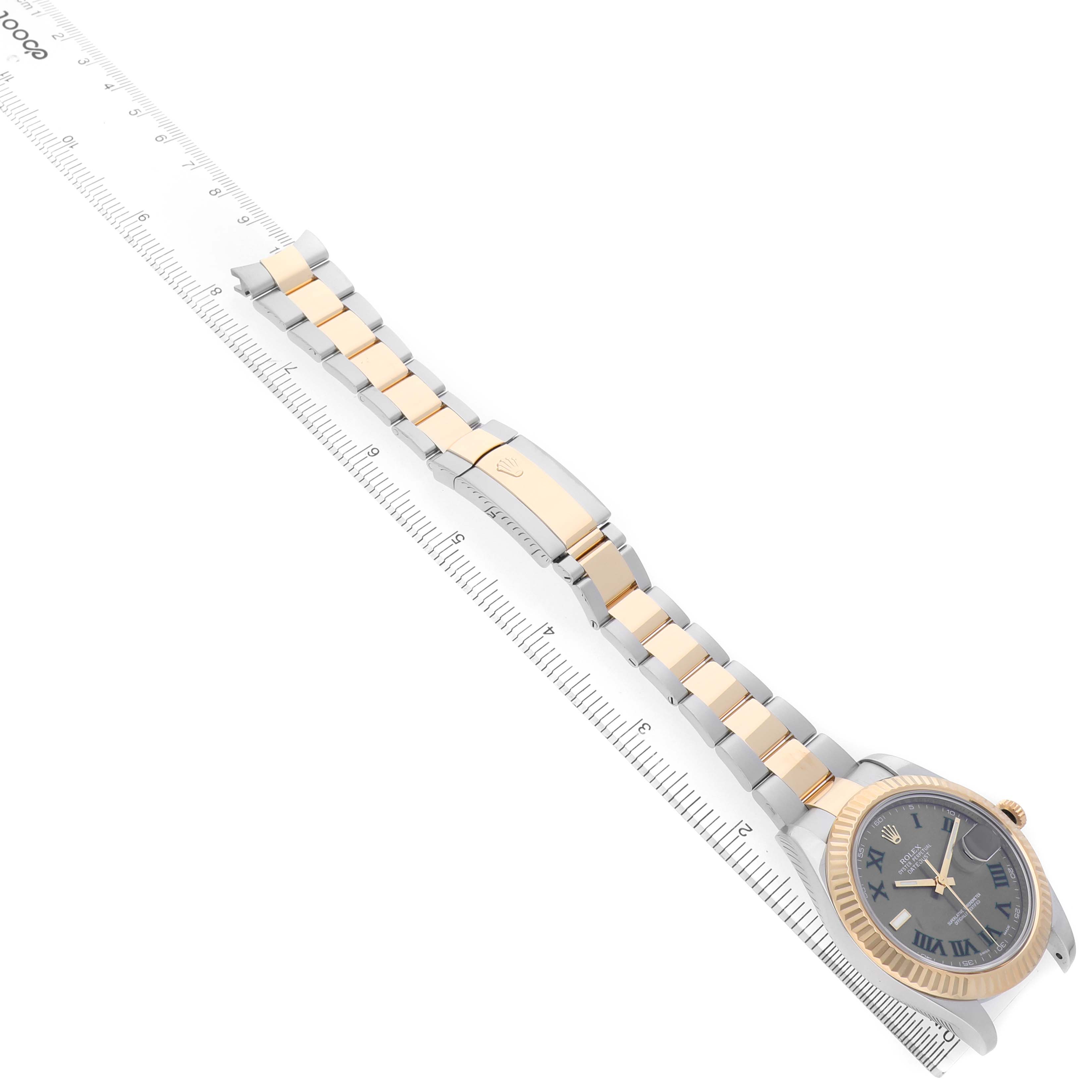 The Rolex Datejust 41 116333 Men's Steel and Gold (two tone) Black Dial watch is shown at an angle displaying the face, bezel, and two-tone bracelet alongside a ruler.