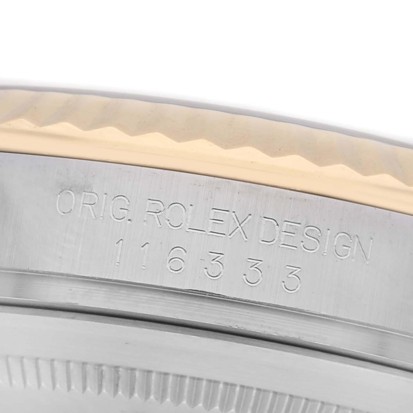 The image shows a close-up of the Rolex Datejust 41 116333 Men
s Steel and Gold (two tone) Black Dial 116333 Men
s Steel and Gold (two tone) Black Dial case side, focusing on the engraved design and model number.