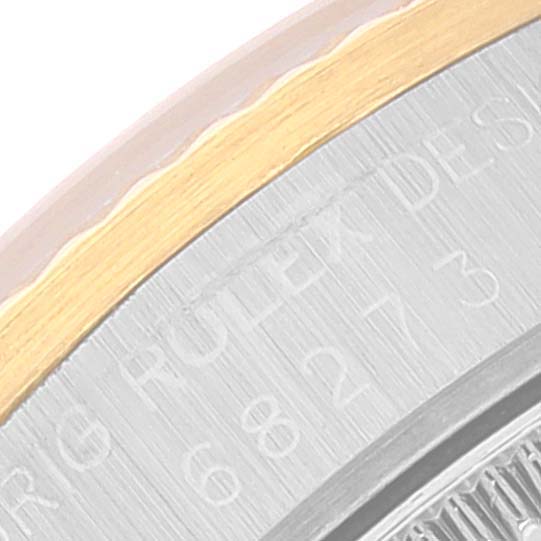 The image shows a close-up of the bezel and part of the outer case of a Rolex Datejust 68273 Women
s Steel and Gold (two tone) Champagne Dial 68273 Women
s Steel and Gold (two tone) Champagne Dial watch, highlighting the engravings.