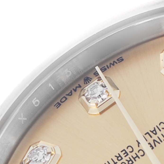 The image shows a close-up of the Rolex Mid-Size 278243 Women
s Steel and Gold (two tone) Champagne Dial 278243 Women
s Steel and Gold (two tone) Champagne Dial watch face, highlighting the indices, hands, and part of the bezel.