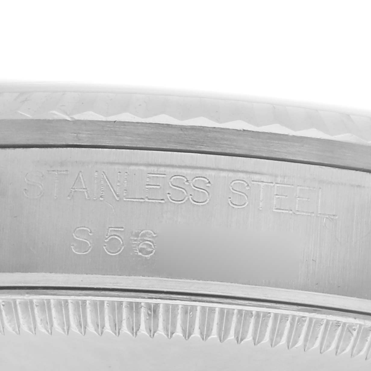 The image shows a close-up of the side of a stainless steel case for a Mid-Size Rolex watch, featuring engraved text.