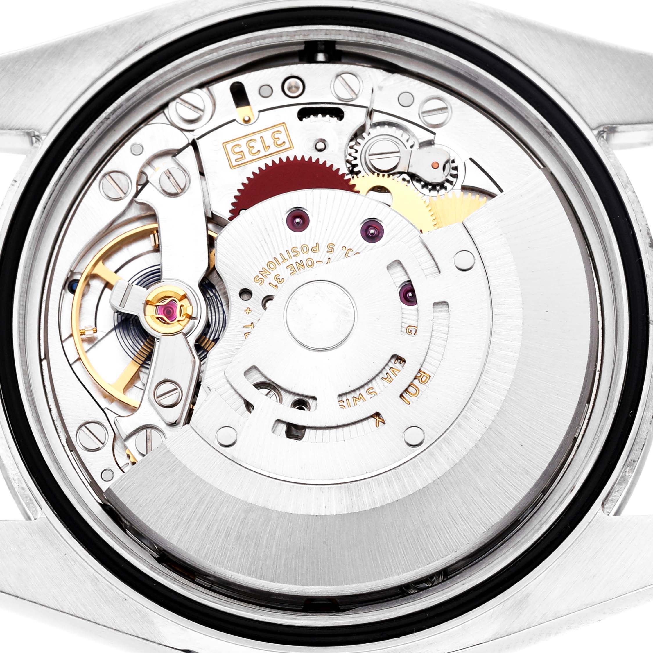 The image shows the movement mechanism of a Rolex Datejust 116200 Men's Stainless Steel Silver Dial, viewed from the back with gears and components visible.