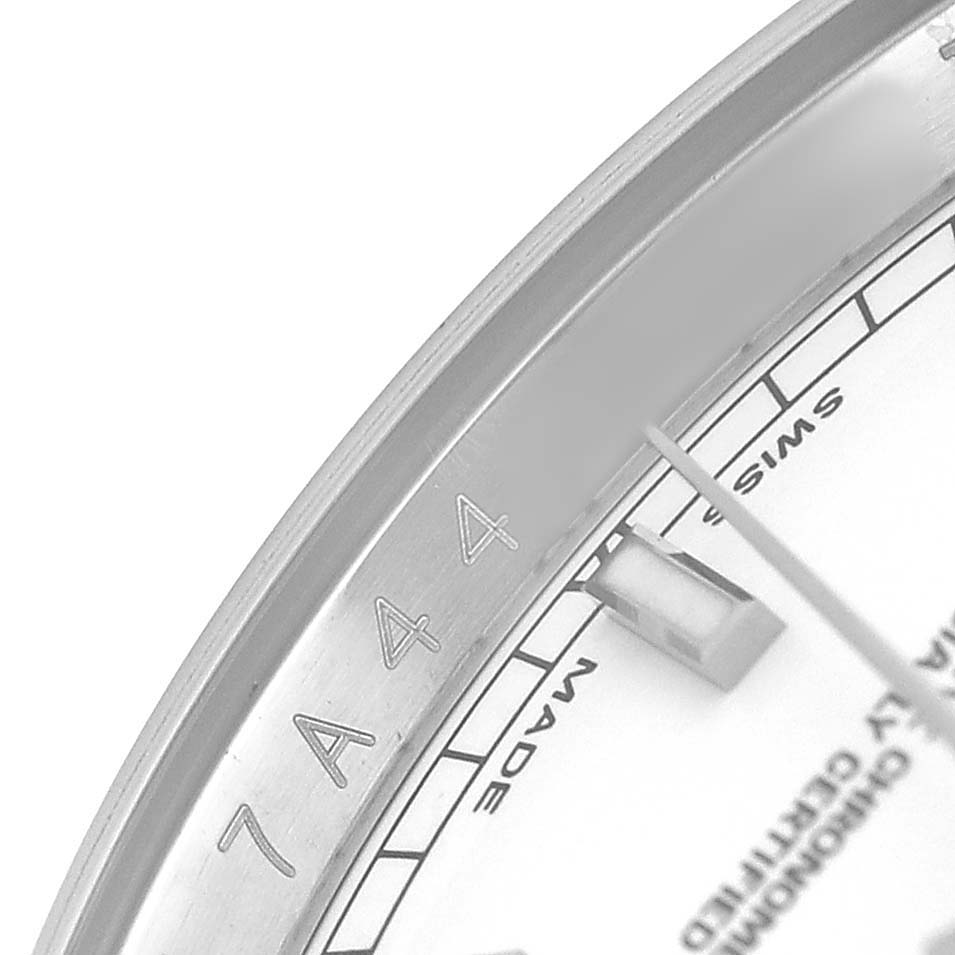 The image shows a close-up of the Rolex Datejust 116200 Men's Stainless Steel Silver Dial's bezel and part of the dial with the "Swiss Made" text.