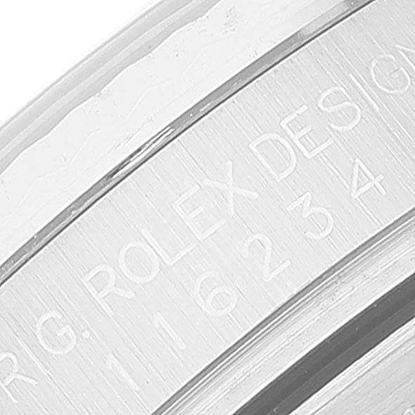 The image shows a close-up of the engraved side of a Rolex Datejust 116234 Men's Stainless Steel Black Dial 116234 Men's Stainless Steel Black Dial watch case.