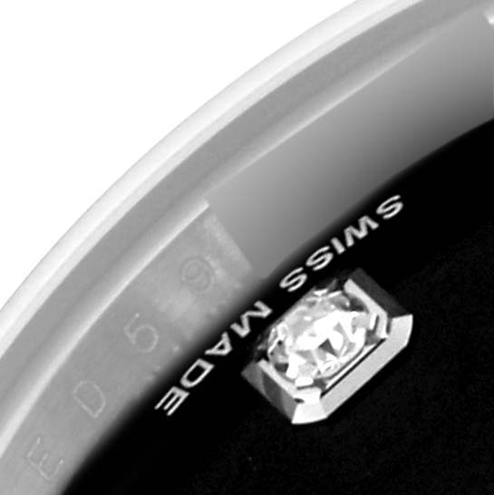 Close-up of a Rolex Datejust 179174 Women's Stainless Steel Black Dial 179174 Women's Stainless Steel Black Dial watch, showing part of the bezel, a diamond marker, and "SWISS MADE" text.
