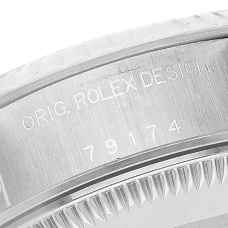 This image shows a close-up of the engraved inner bezel of a Rolex Datejust 79174 Women's Stainless Steel Black Dial 79174 Women's Stainless Steel Black Dial watch, displaying the serial and model numbers.