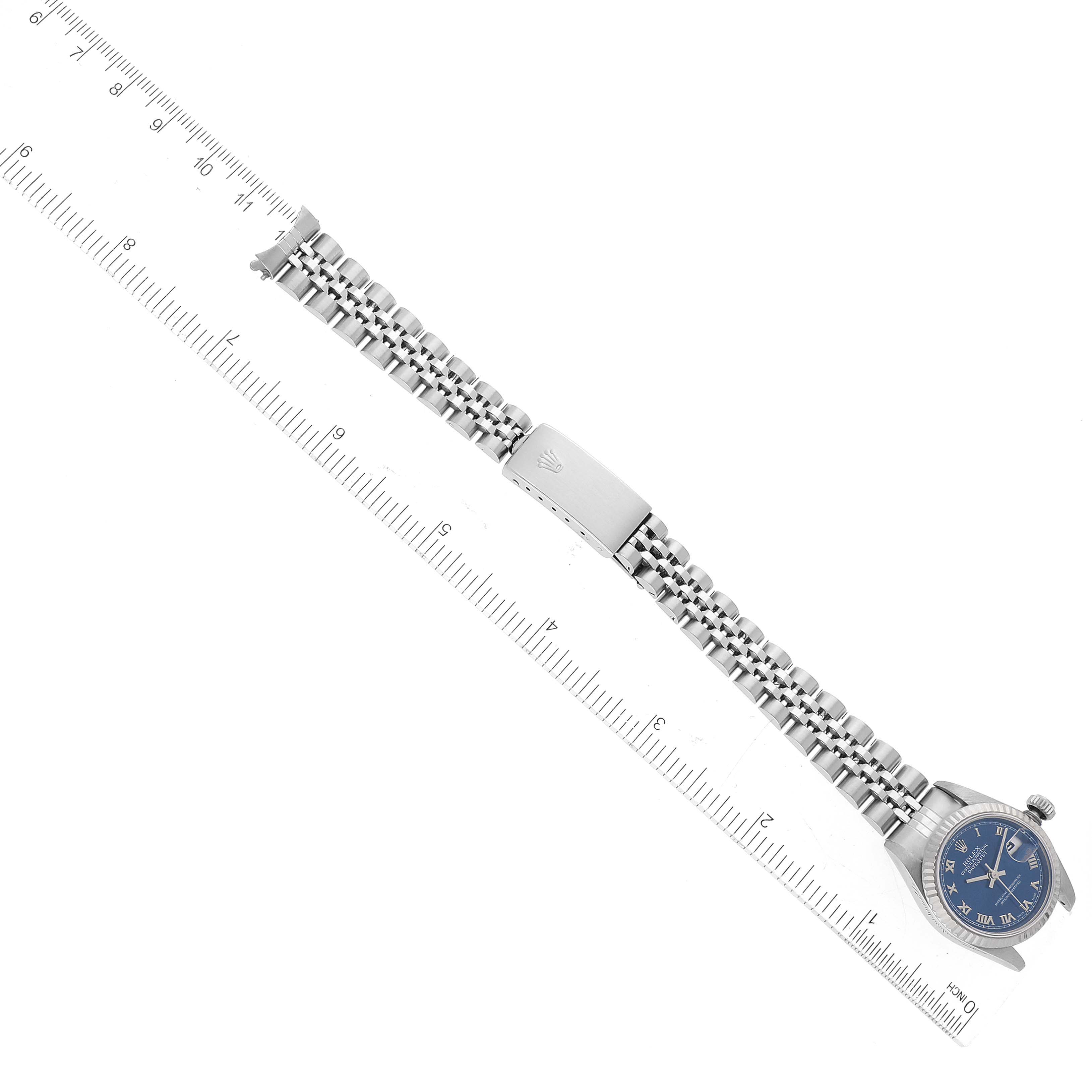This image shows a Rolex Datejust 69174 Women's Stainless Steel Blue Dial 69174 Women's Stainless Steel Blue Dial watch laid flat, displaying the case, dial, bracelet, and clasp, with a ruler beside for scale.