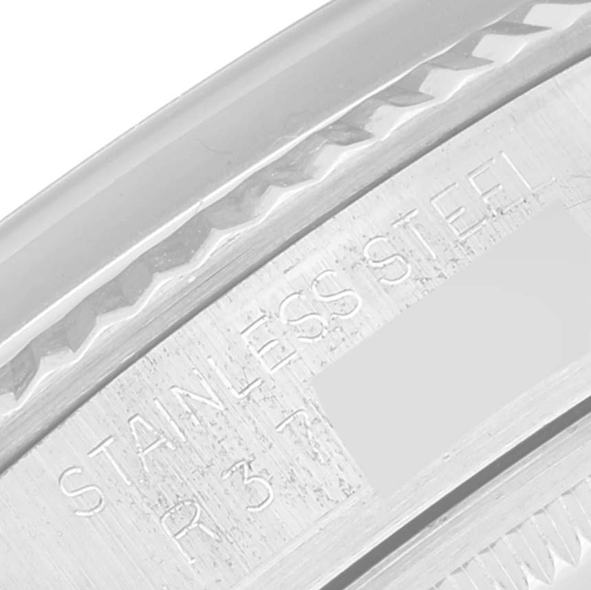 This close-up image shows the stainless steel engraving and part of the fluted bezel of a Rolex Datejust 16014 Men's Stainless Steel Grey Dial 16014 Men's Stainless Steel Grey Dial watch.