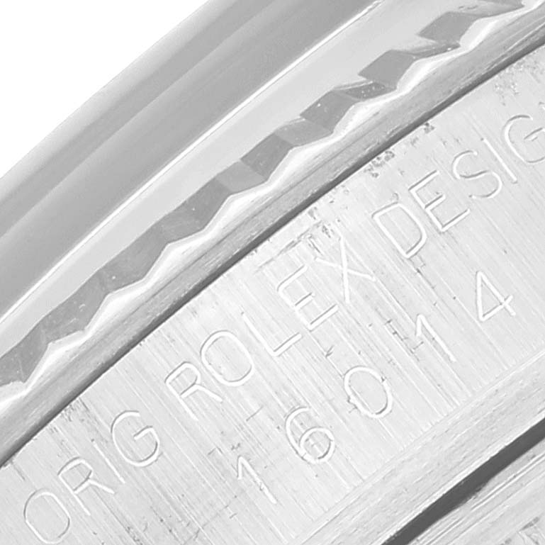 This image shows a close-up of the Rolex Datejust 16014 Men's Stainless Steel Grey Dial 16014 Men's Stainless Steel Grey Dial model's engraved bezel and case back.