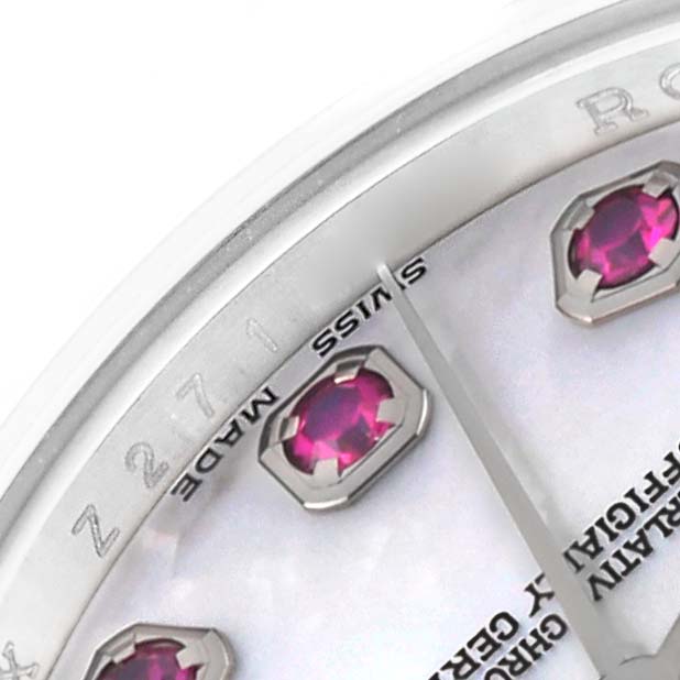 The image shows a close-up of the dial of a Rolex Datejust 179174 Women's Stainless Steel Mother of Pearl Dial 179174 Women's Stainless Steel Mother of Pearl Dial watch, featuring ruby hour markers and the "Swiss Made" inscription.