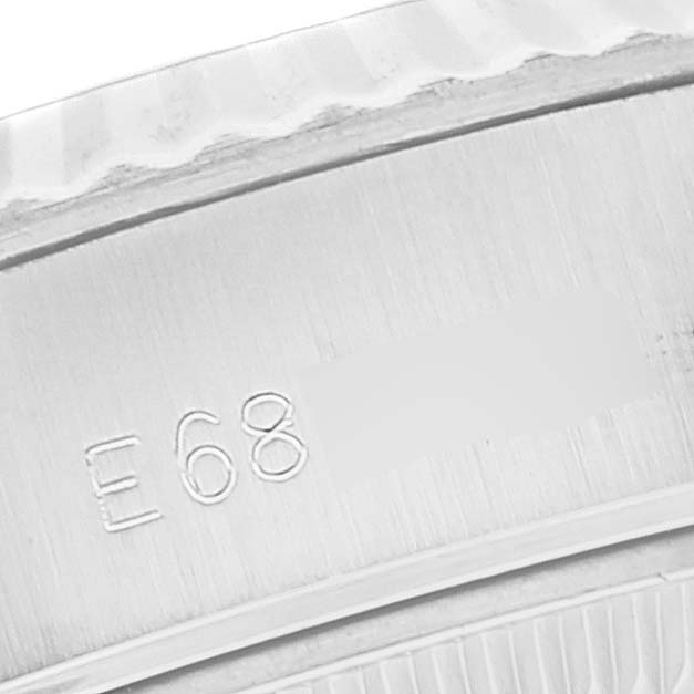 This image shows the close-up of the serial engraving and the fluted bezel of a Rolex Datejust 69174 Women's Stainless Steel Silver Dial 69174 Women's Stainless Steel Silver Dial.
