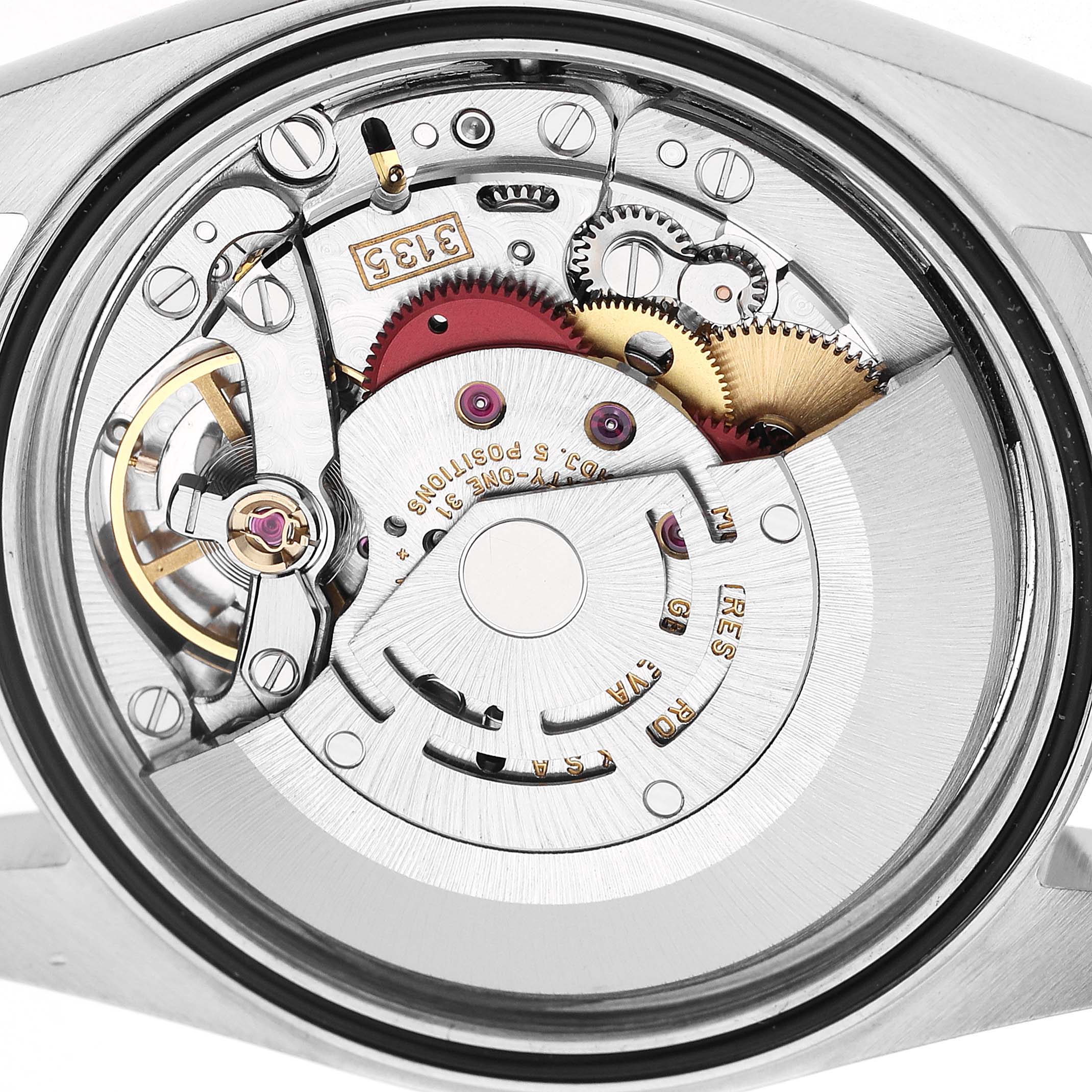 The image shows the movement mechanism of a Rolex Datejust 16234 Men's Stainless Steel Silver Dial watch from a rear angle, highlighting gears and components.