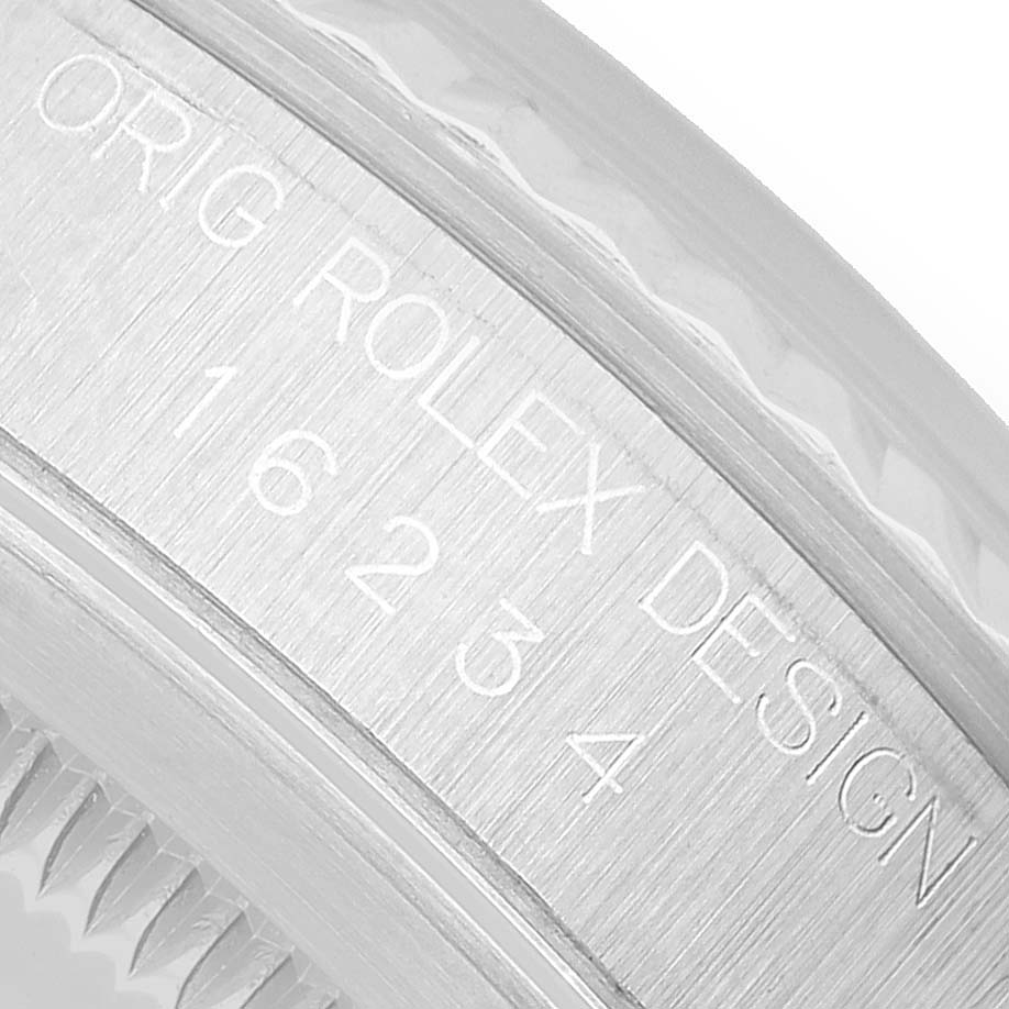 The image shows a close-up of the engraved side view of the bezel on a Rolex Datejust 16234 Men's Stainless Steel Silver Dial, displaying the model information and design.