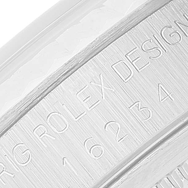 This close-up image shows the side engraving of a Rolex Datejust 16234 Men's Stainless Steel Silver Dial 16234 Men's Stainless Steel Silver Dial watch, featuring identification details.
