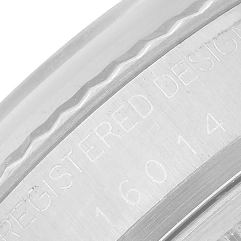 This image shows a close-up of the side of the case for the Rolex Vintage Collection 16014 Men's Stainless Steel Silver Dial 16014 Men's Stainless Steel Silver Dial model, displaying engraved text and serial number.