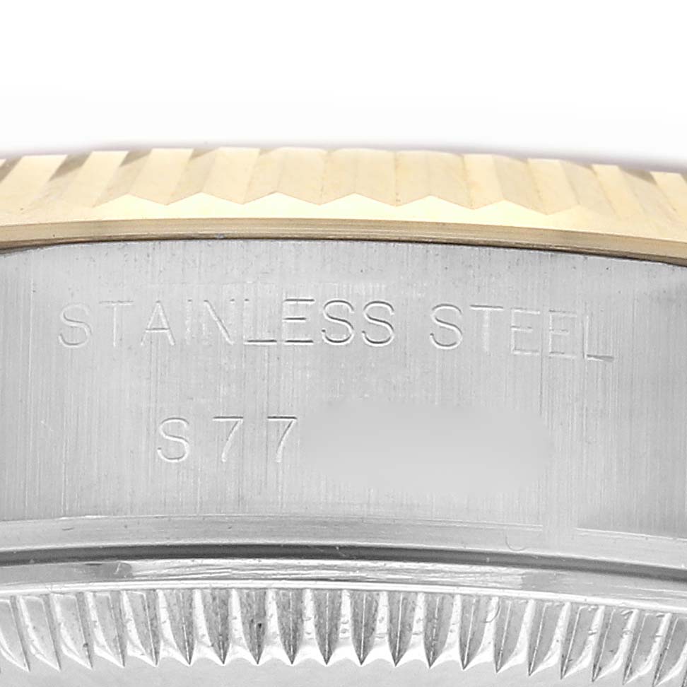 The image shows a close-up of the case side and fluted bezel of a Rolex Datejust 69173 Women's Steel and Gold (two tone) Champagne Dial 69173 Women's Steel and Gold (two tone) Champagne Dial, highlighting the "STAINLESS STEEL" engraving.