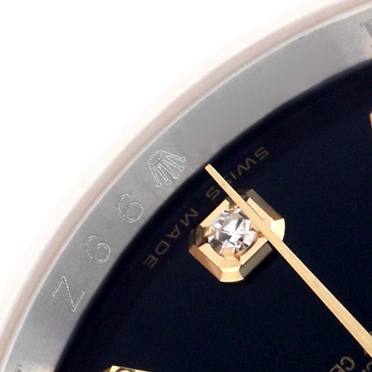 This image shows a close-up of the Rolex Datejust 116233 Men
s Steel and Gold (two tone) Black Dial 116233 Men
s Steel and Gold (two tone) Black Dial
s dial, including a diamond hour marker and part of the bezel with engravings.