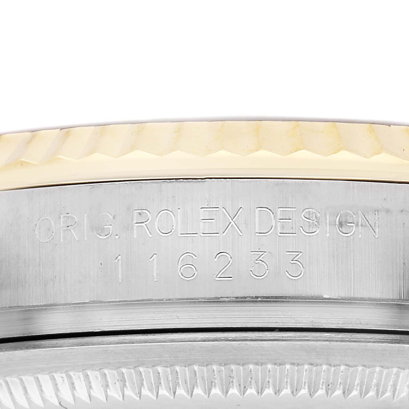 This image shows a close-up of the side of a Rolex Datejust 116233 Men
s Steel and Gold (two tone) Black Dial 116233 Men
s Steel and Gold (two tone) Black Dial watch, highlighting the engraved serial number and fluted bezel.