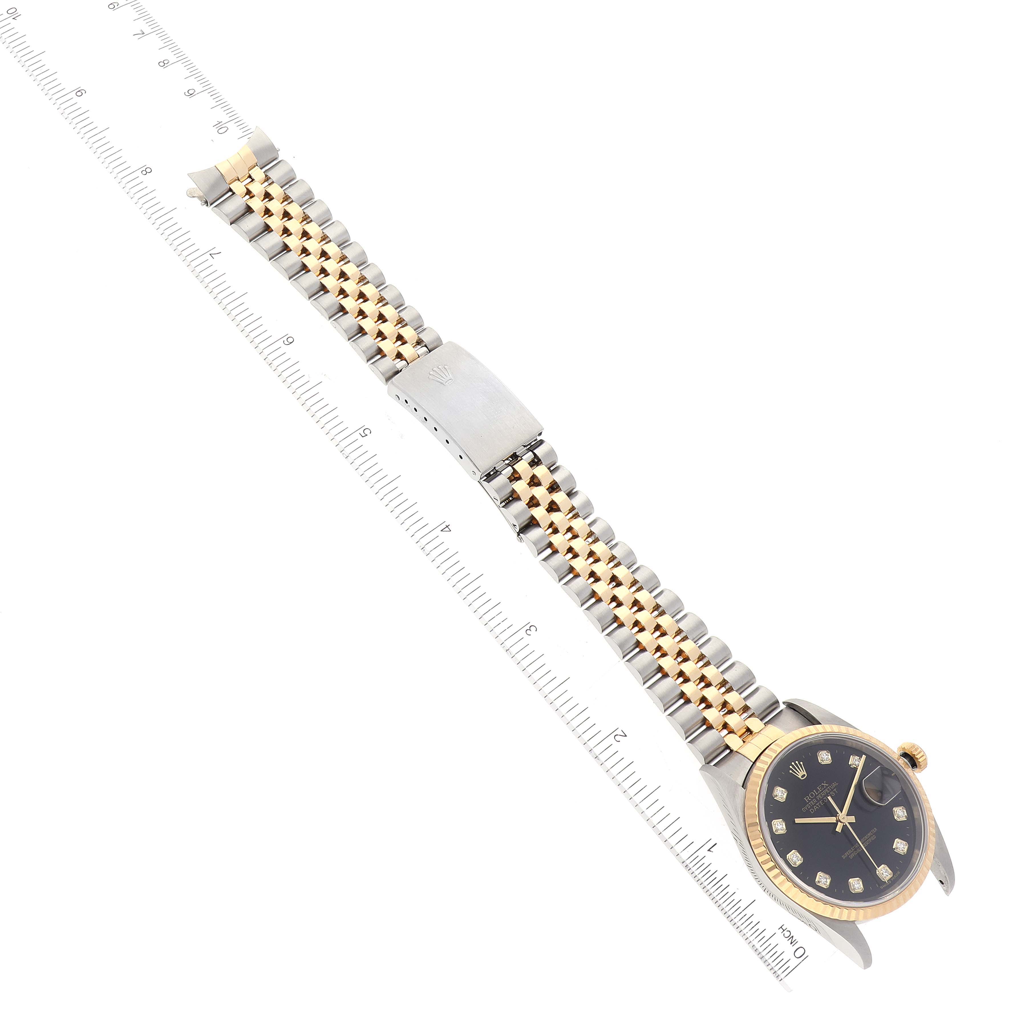 This image shows the Rolex Datejust 16233 Men's Steel and Gold (two tone) Black Dial 16233 Men's Steel and Gold (two tone) Black Dial watch laid flat with its face, bezel, and two-tone bracelet visible.