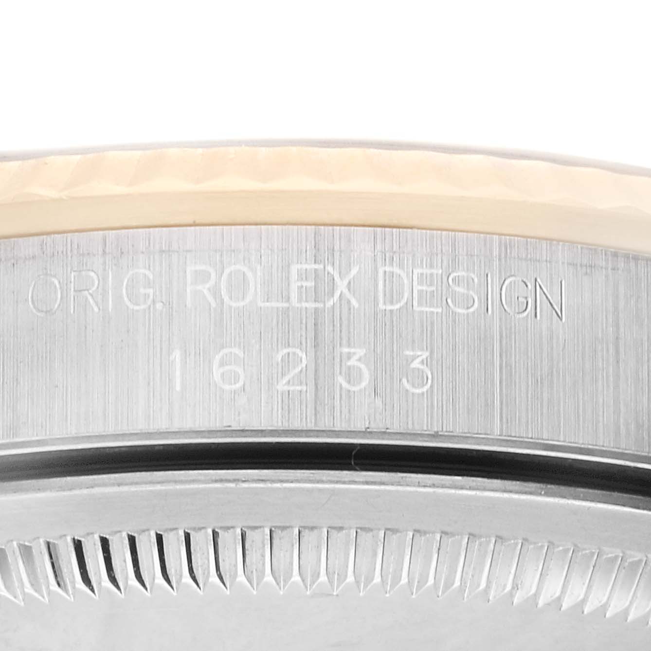 The image shows a close-up side view of the bezel and case edge of a Rolex Datejust 16233 Men's Steel and Gold (two tone) Black Dial 16233 Men's Steel and Gold (two tone) Black Dial watch, revealing engraved text and numbers.