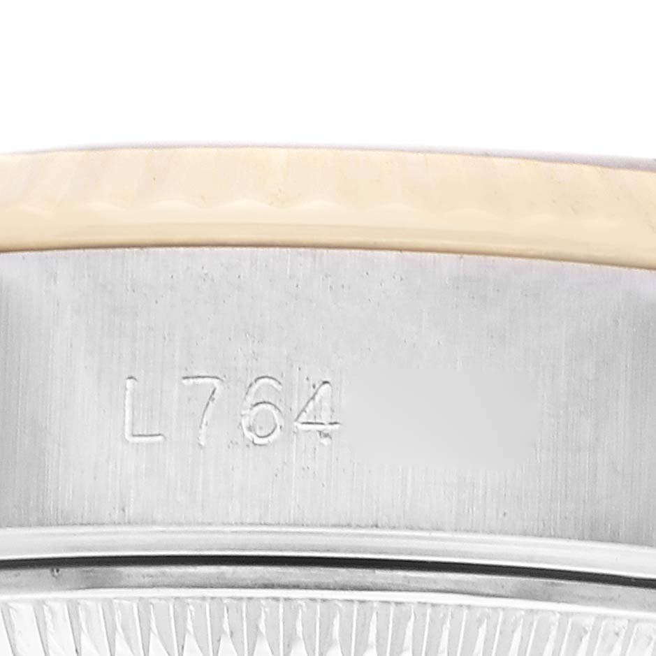 The image shows a close-up of the watch's side, focusing on the engravings on the bezel and case edge of the Rolex Datejust 69173 Women's Steel and Gold (two tone) Champagne Dial 69173 Women's Steel and Gold (two tone) Champagne Dial.