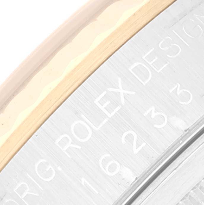 This close-up image shows the engraved details on the side of the Rolex Datejust 16233 Men's Steel and Gold (two tone) Grey Dial 16233 Men's Steel and Gold (two tone) Grey Dial watch case.