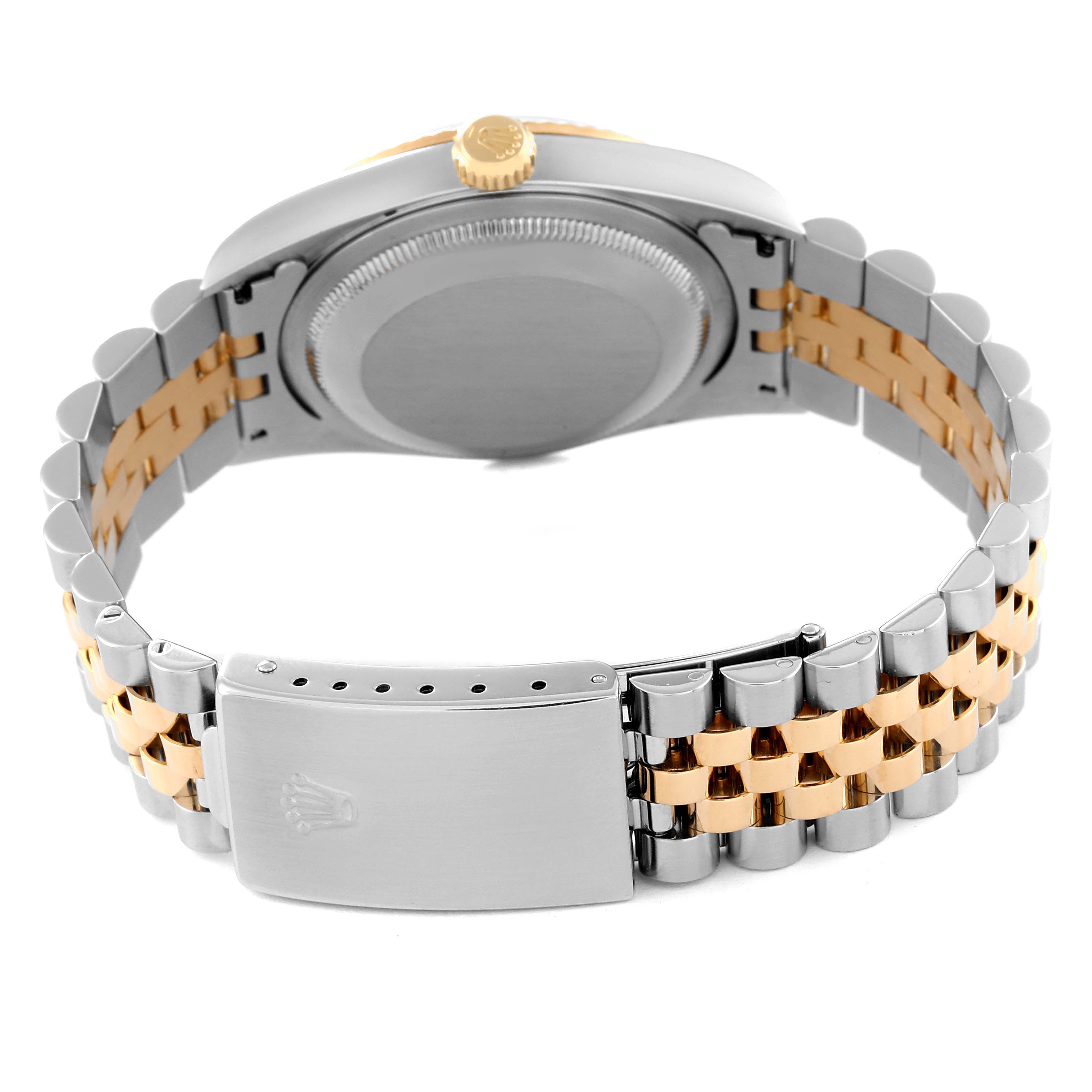 The image displays the underside of a Rolex Datejust 16233 Men's Steel and Gold (two tone) Grey Dial 16233 Men's Steel and Gold (two tone) Grey Dial watch, showcasing the case back, crown, and two-tone bracelet with a clasp.