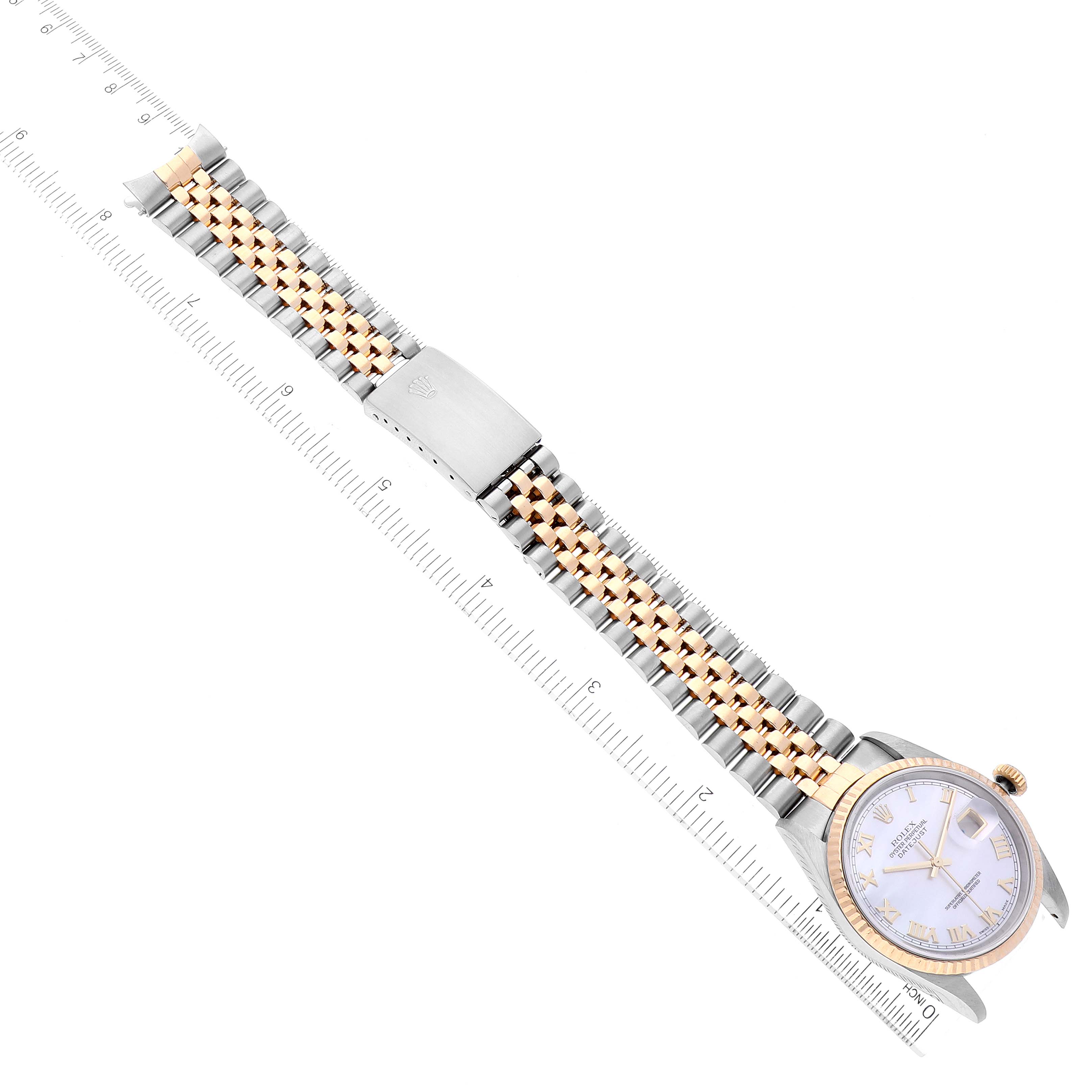 The image shows a Rolex Datejust 16233 Men's Steel and Gold (two tone) Mother of Pearl Dial 16233 Men's Steel and Gold (two tone) Mother of Pearl Dial watch laid flat, highlighting its two-tone bracelet, clasp, and face with a ruler for scale.