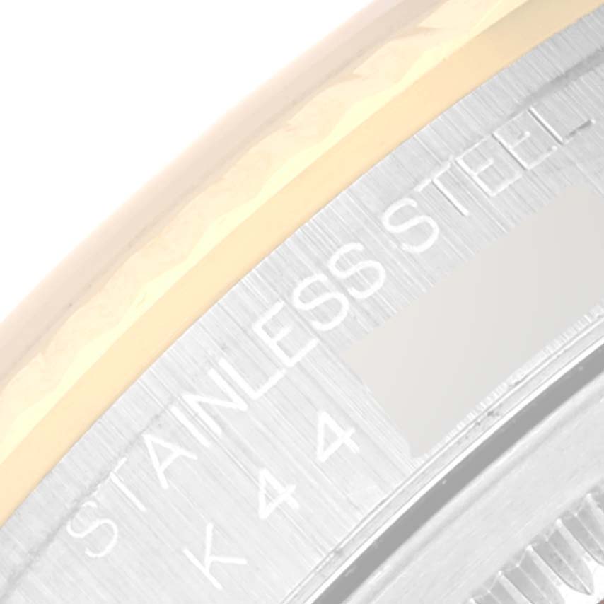 This close-up image shows the edge and engraving "STAINLESS STEEL" on the back of a Rolex Datejust 16233 Men's Steel and Gold (two tone) Mother of Pearl Dial 16233 Men's Steel and Gold (two tone) Mother of Pearl Dial watch.