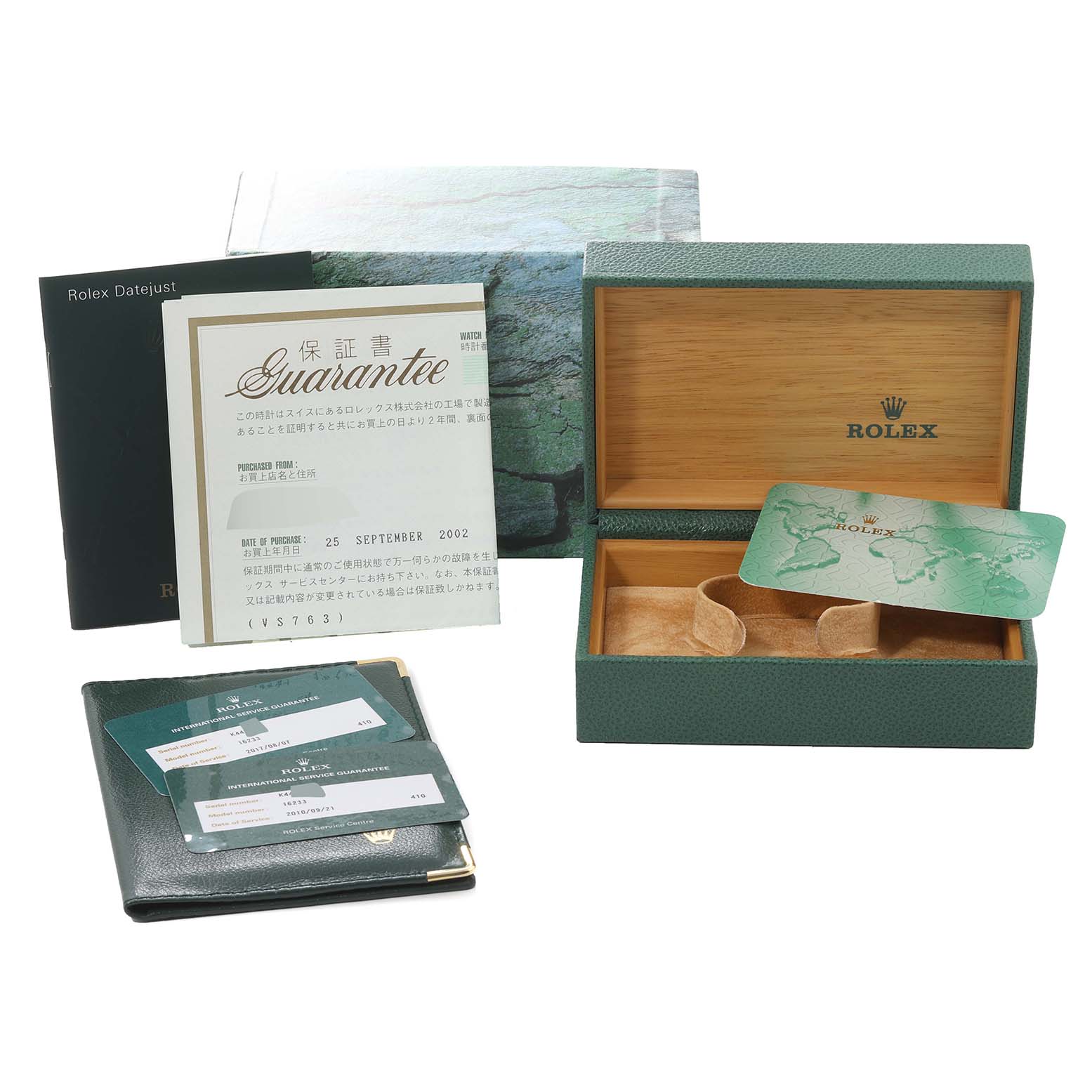 The image shows the accessories for a Rolex Datejust 16233 Men's Steel and Gold (two tone) Mother of Pearl Dial 16233 Men's Steel and Gold (two tone) Mother of Pearl Dial watch, including the box, guarantee papers, and information booklets.