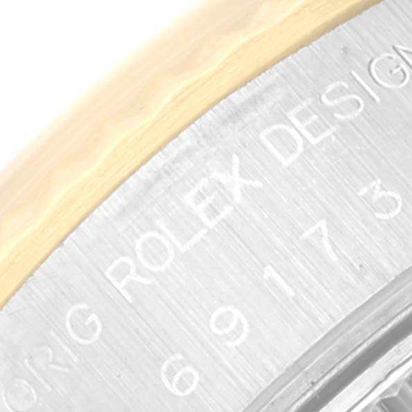 This image shows a close-up of the engraved "Rolex Design" on the bezel of a Rolex Datejust 69173 Women's Steel and Gold (two tone) Silver Dial 69173 Women's Steel and Gold (two tone) Silver Dial watch.