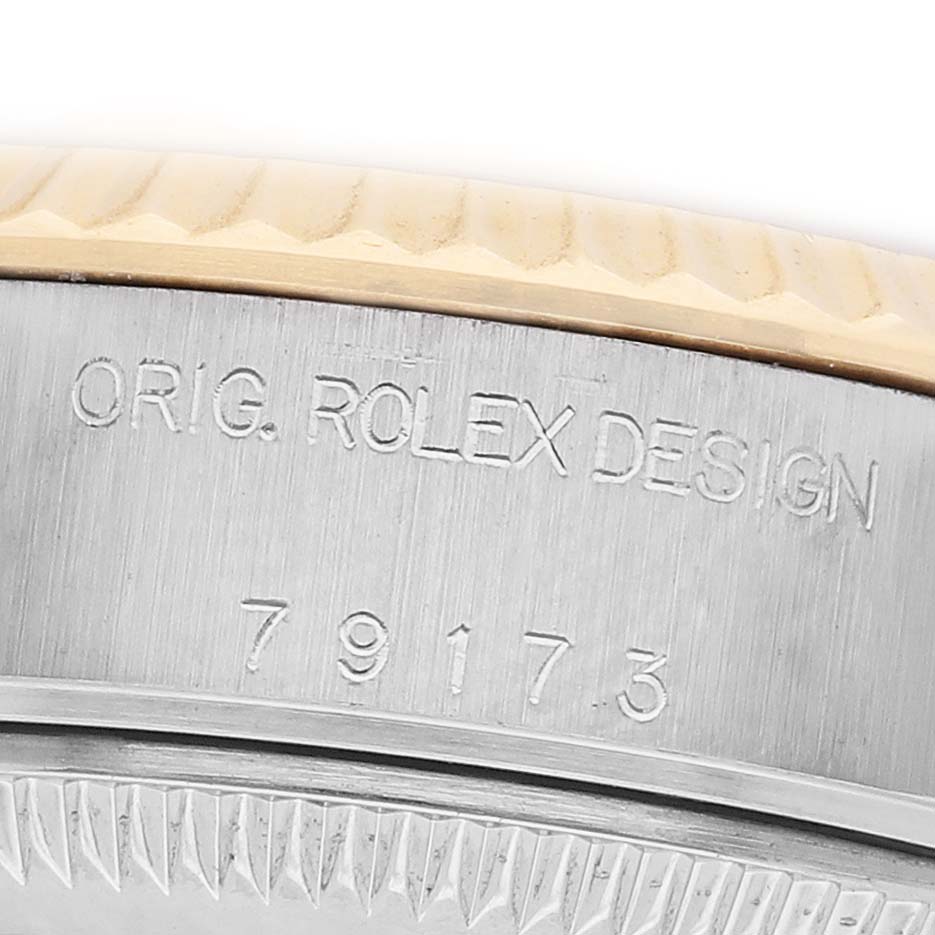 The image shows a close-up of a Rolex Datejust 79173 Women's Steel and Gold (two tone) Silver Dial model case with engraved markings on the side.